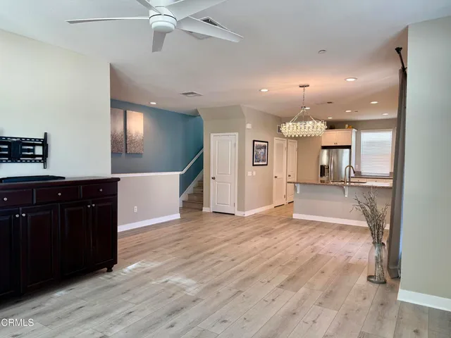 a view of a kitchen with a sink and a refrigerator
