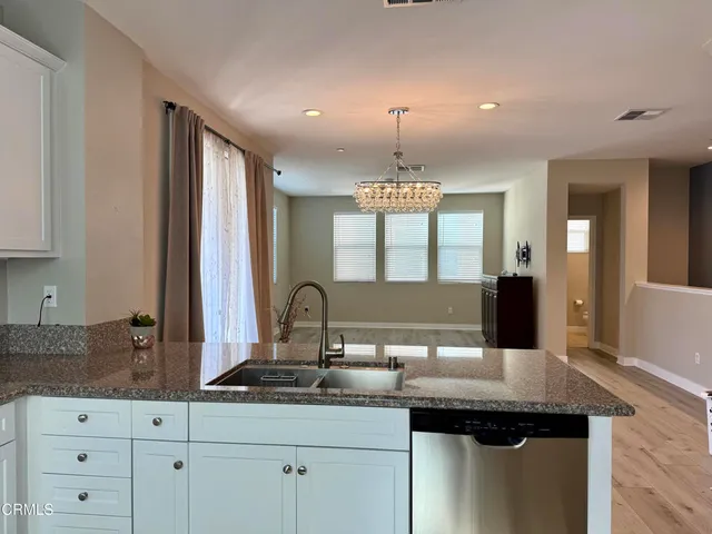 a kitchen with a sink and chandelier