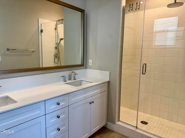 a bathroom with a shower sink and mirror
