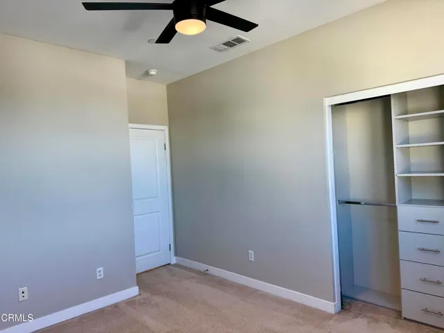 an empty room with closet area
