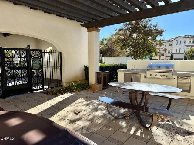 a view of a patio with a table and chairs and potted plants