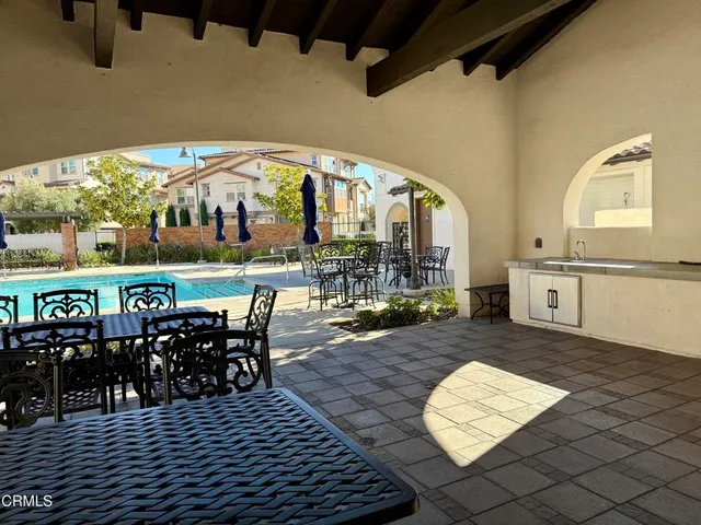 a view of a swimming pool with outdoor seating