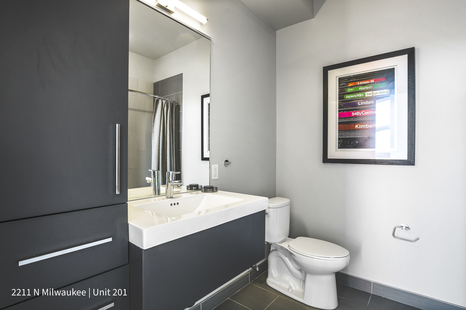 Undisclosed Address Chicago, IL 60647 - Photo 19 of 23 a bathroom with a toilet sink and mirror