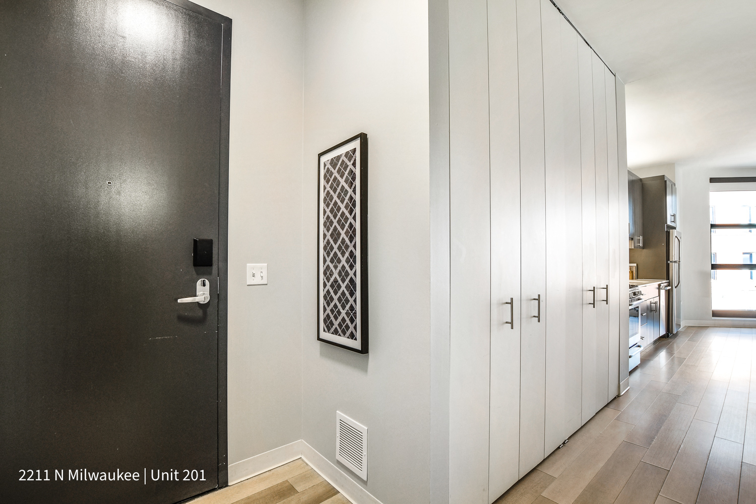 Undisclosed Address Chicago, IL 60647 - Photo 2 of 23 a view of a hallway with wooden floor