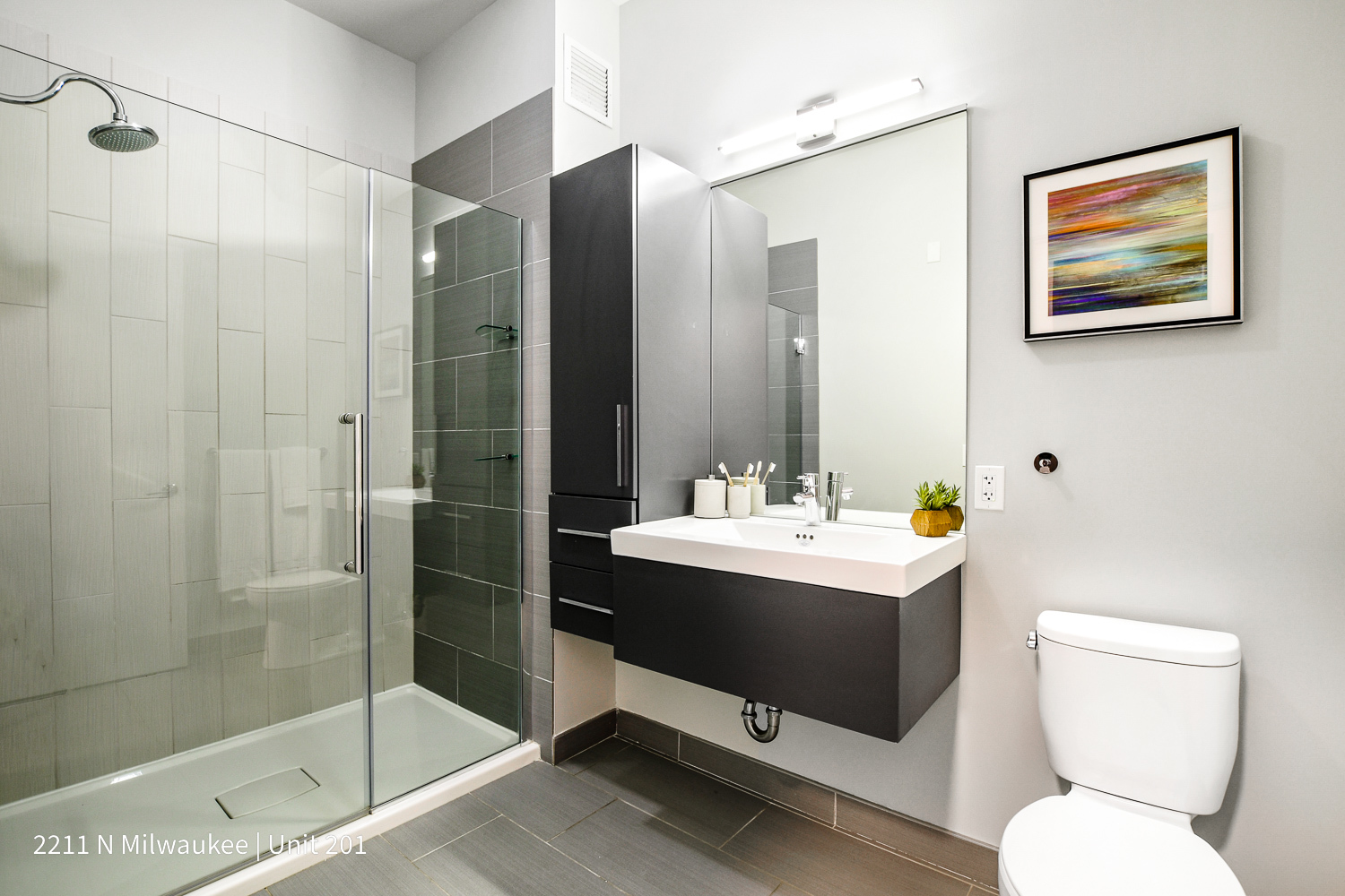 Undisclosed Address Chicago, IL 60647 - Photo 3 of 23 a bathroom with a toilet sink and shower