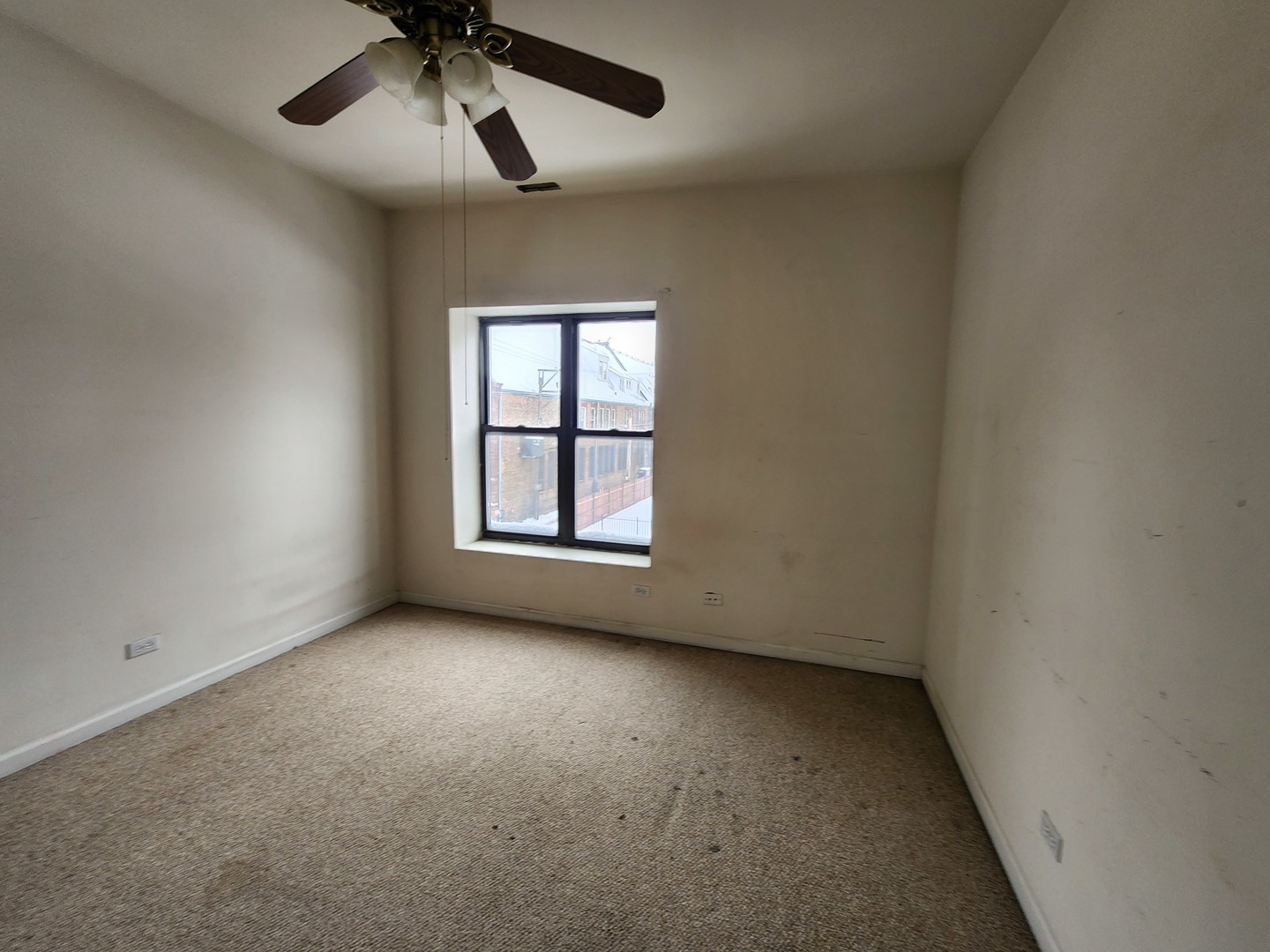 346 East 41st Street, Unit 2 Chicago, IL 60653 - Photo 9 of 9 an empty room with a window and a ceiling fan