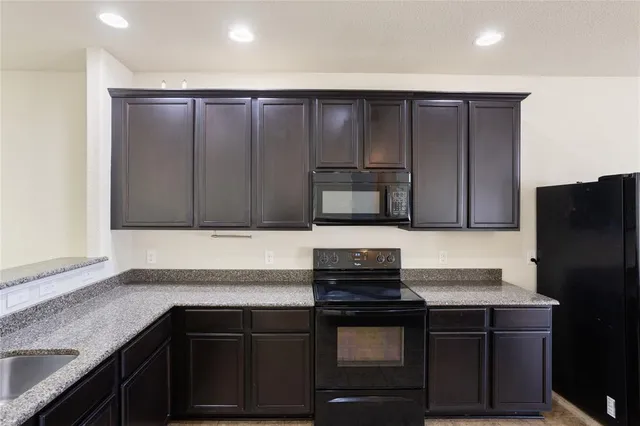 a kitchen with a sink and a refrigerator