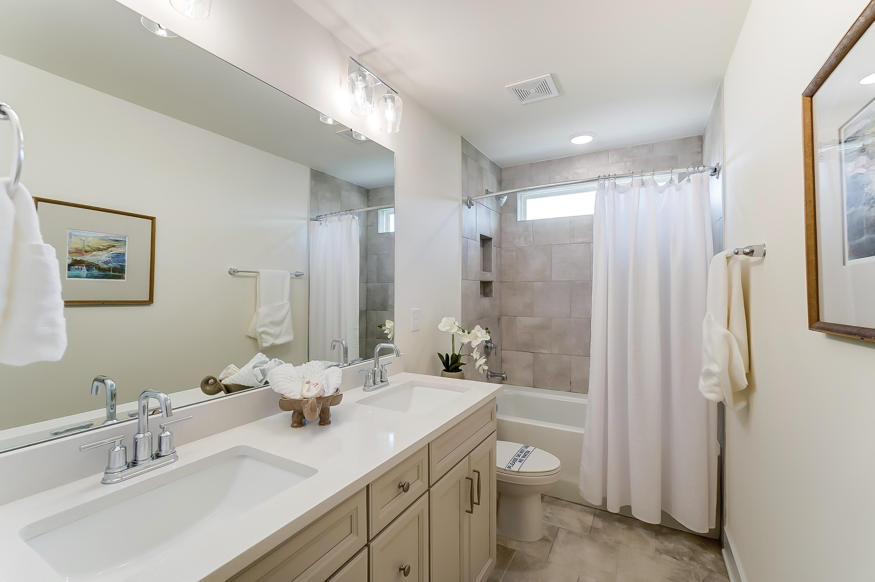 3450 Piedmont Drive Raleigh, NC 27604 - Photo 30 of 34 a bathroom with a double vanity sink toilet mirror and shower