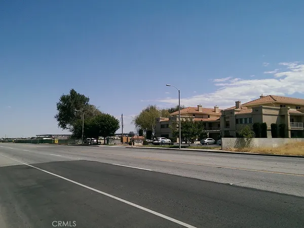 a view of street with a cars parked in front of it