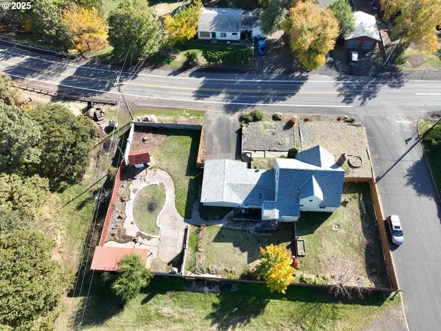 an aerial view of a house with a yard and lake view