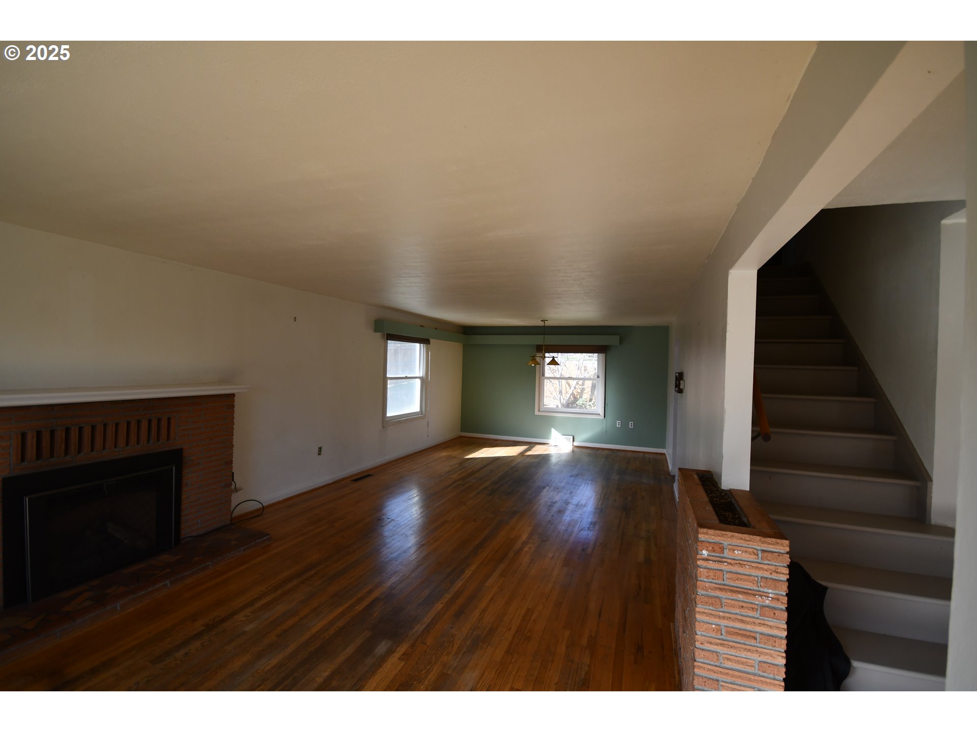 4233 Chenoweth Road The Dalles, OR 97058 - Photo 45 of 46 a view of empty room with wooden floor and fireplace