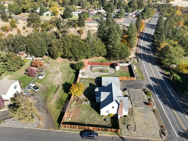 an aerial view of multiple houses with yard