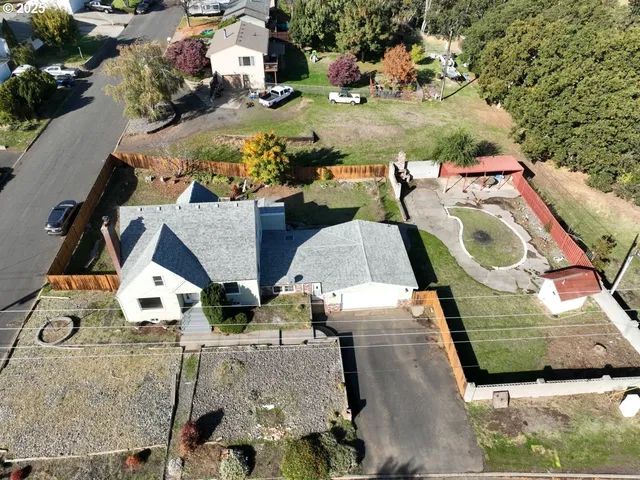 an aerial view of residential houses with outdoor space