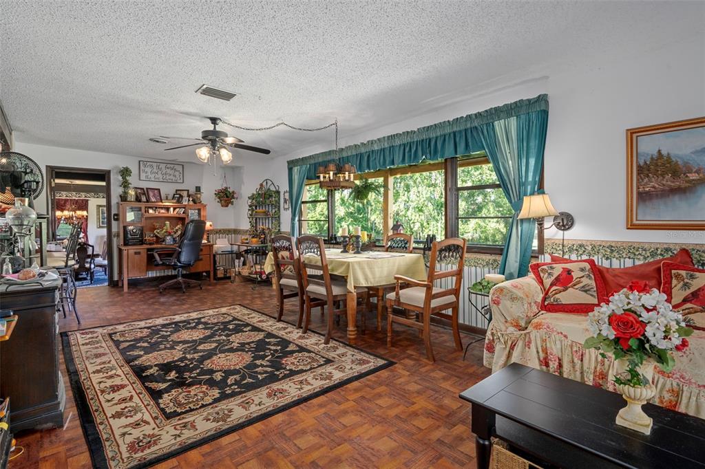 25927 Old Spring Lake Road Brooksville, FL 34601 - Photo 16 of 60 a living room with furniture and a large window