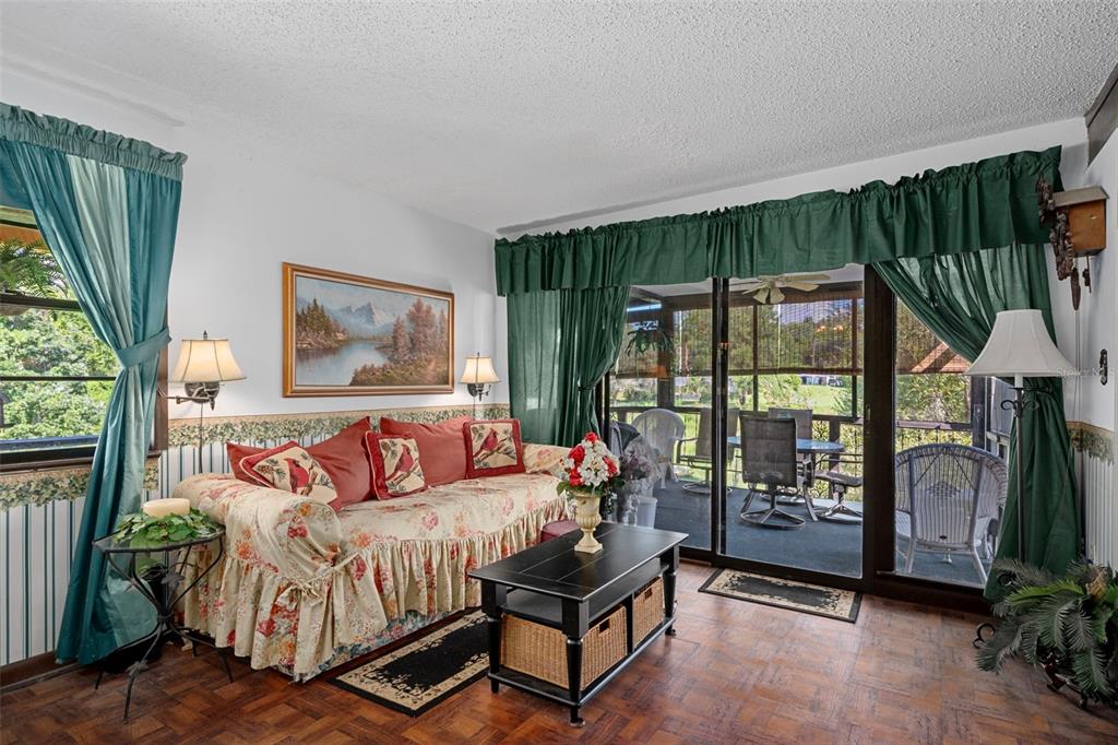 25927 Old Spring Lake Road Brooksville, FL 34601 - Photo 17 of 60 a bedroom with furniture and a floor to ceiling window