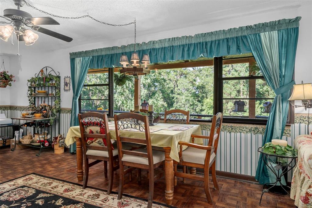 25927 Old Spring Lake Road Brooksville, FL 34601 - Photo 18 of 60 a view of a dining room with furniture window and outside view
