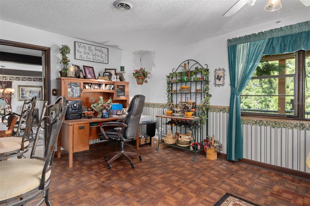 25927 Old Spring Lake Road Brooksville, FL 34601 - Photo 20 of 60 a view of a workspace with furniture and a window