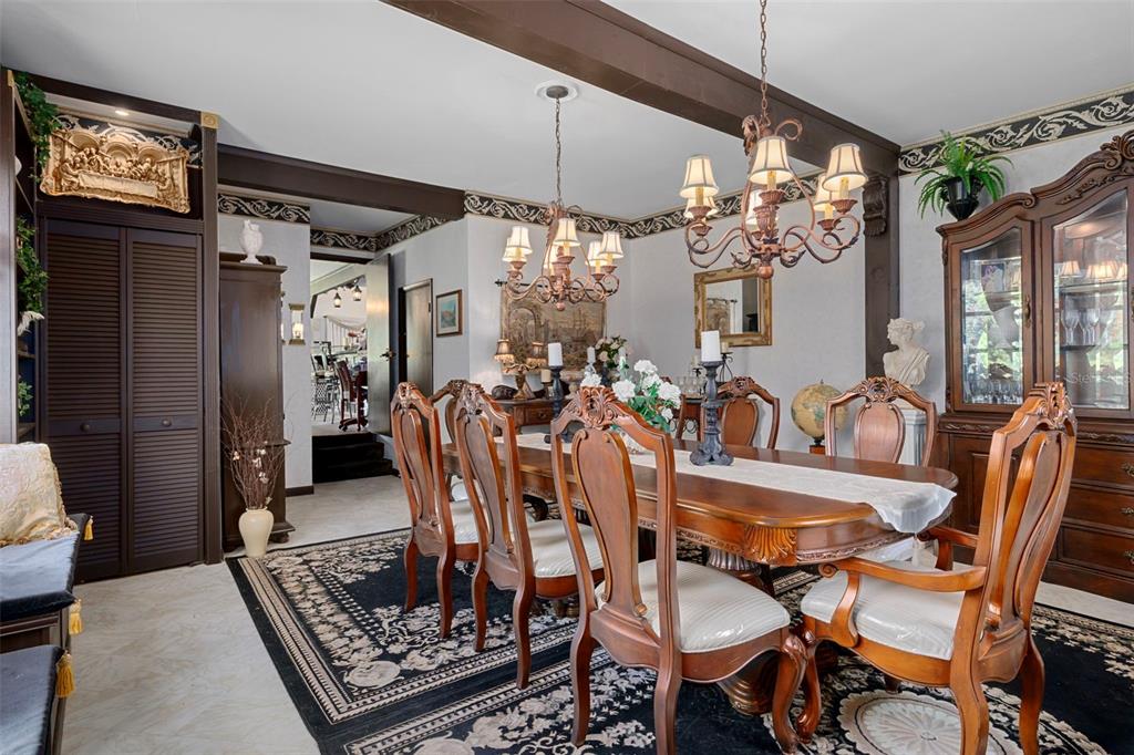25927 Old Spring Lake Road Brooksville, FL 34601 - Photo 26 of 60 a dining room with furniture a chandelier and window