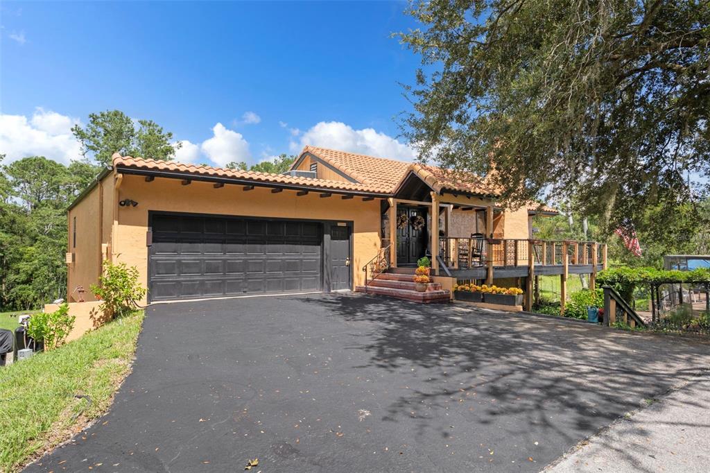 25927 Old Spring Lake Road Brooksville, FL 34601 - Photo 3 of 60 a view of a house with a patio and a yard