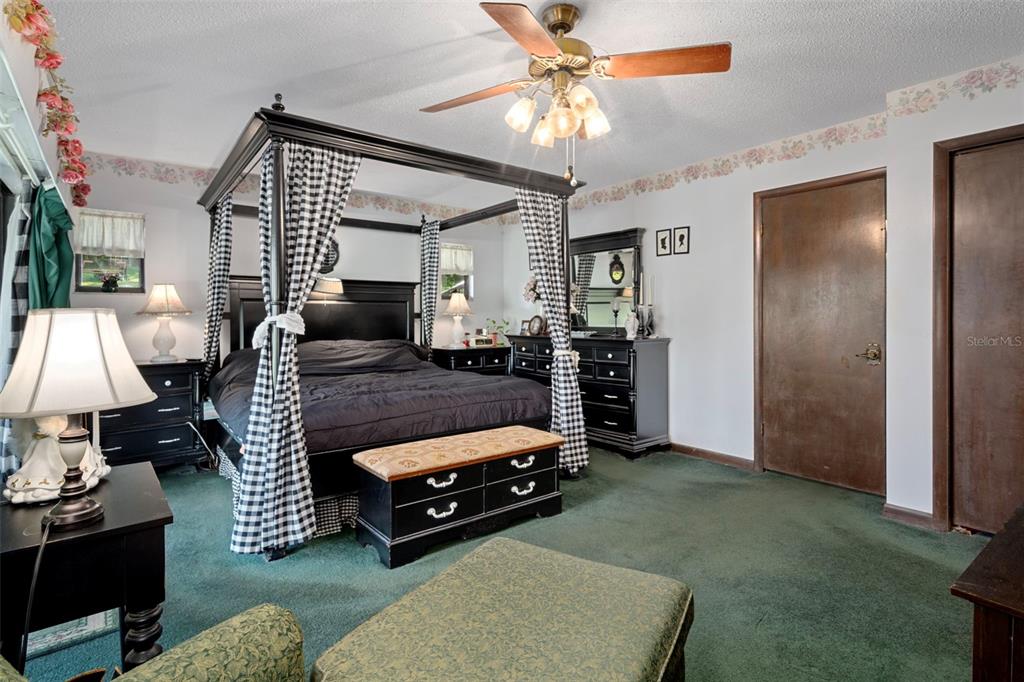 25927 Old Spring Lake Road Brooksville, FL 34601 - Photo 34 of 60 a living room with furniture and a chandelier