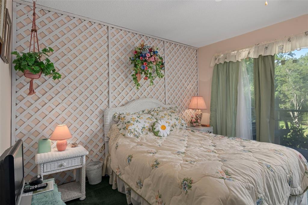 25927 Old Spring Lake Road Brooksville, FL 34601 - Photo 38 of 60 a bedroom with a bed and a painting on the wall