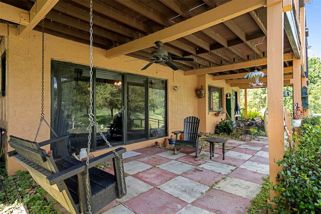 25927 Old Spring Lake Road Brooksville, FL 34601 - Photo 41 of 60 a building outdoor space with patio furniture and wooden floor