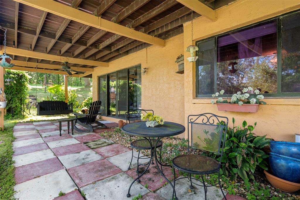 25927 Old Spring Lake Road Brooksville, FL 34601 - Photo 42 of 60 a backyard of a house with yard and outdoor seating