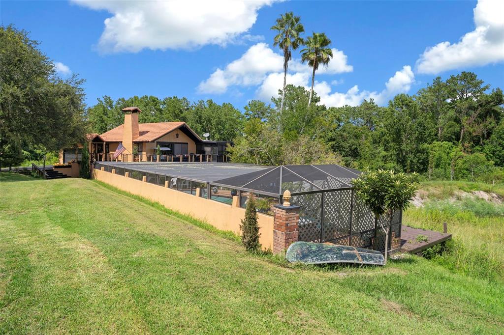 25927 Old Spring Lake Road Brooksville, FL 34601 - Photo 50 of 60 a view of a house with a yard and a terrace