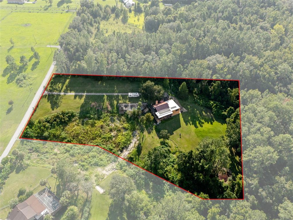 25927 Old Spring Lake Road Brooksville, FL 34601 - Photo 56 of 60 a view of a yard with wooden floor