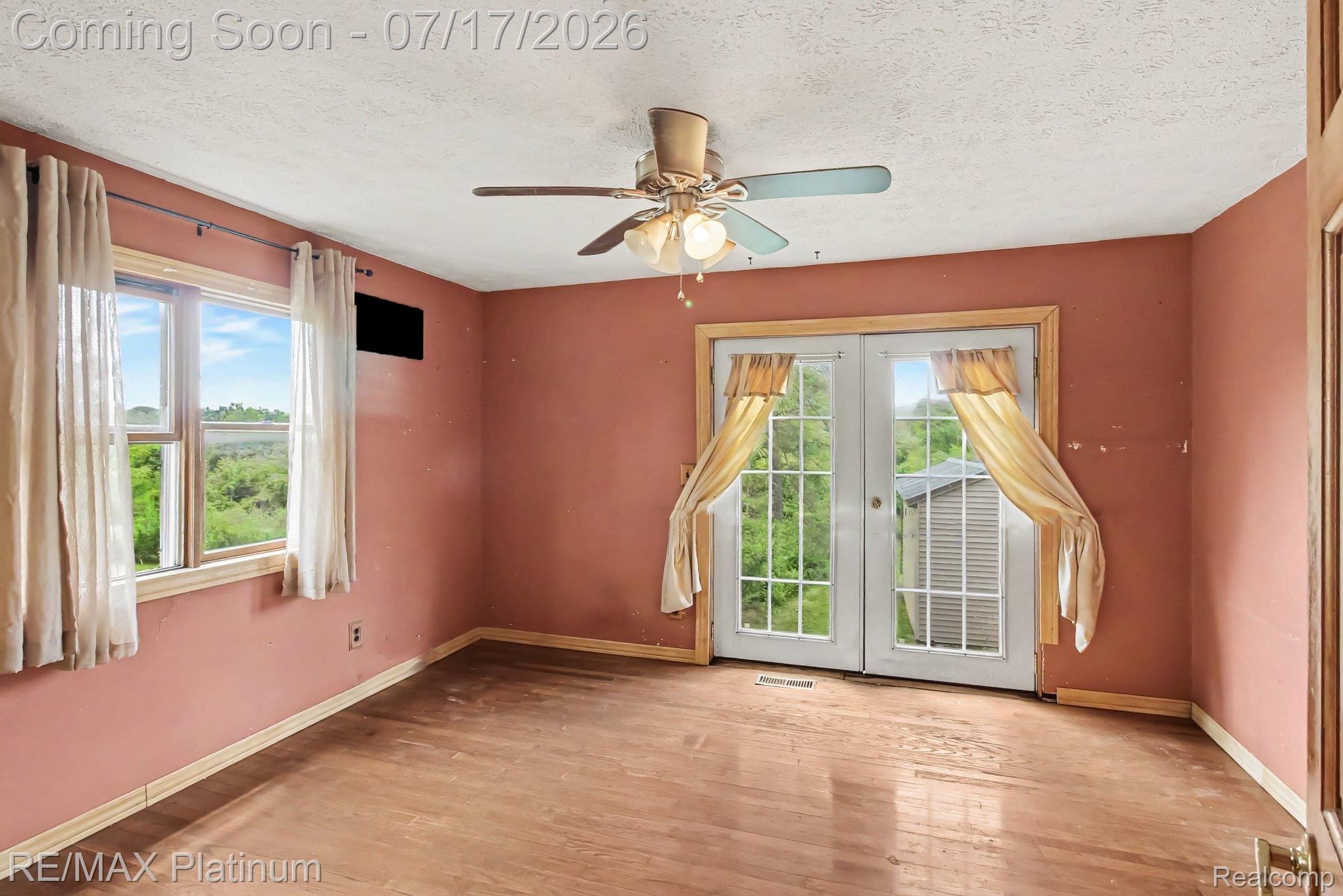 4205 Musson Road Howell, MI 48855 - Photo 15 of 23 Interior room featuring wood-finish flooring, a ceiling fan, and a window with a green landscape backdrop