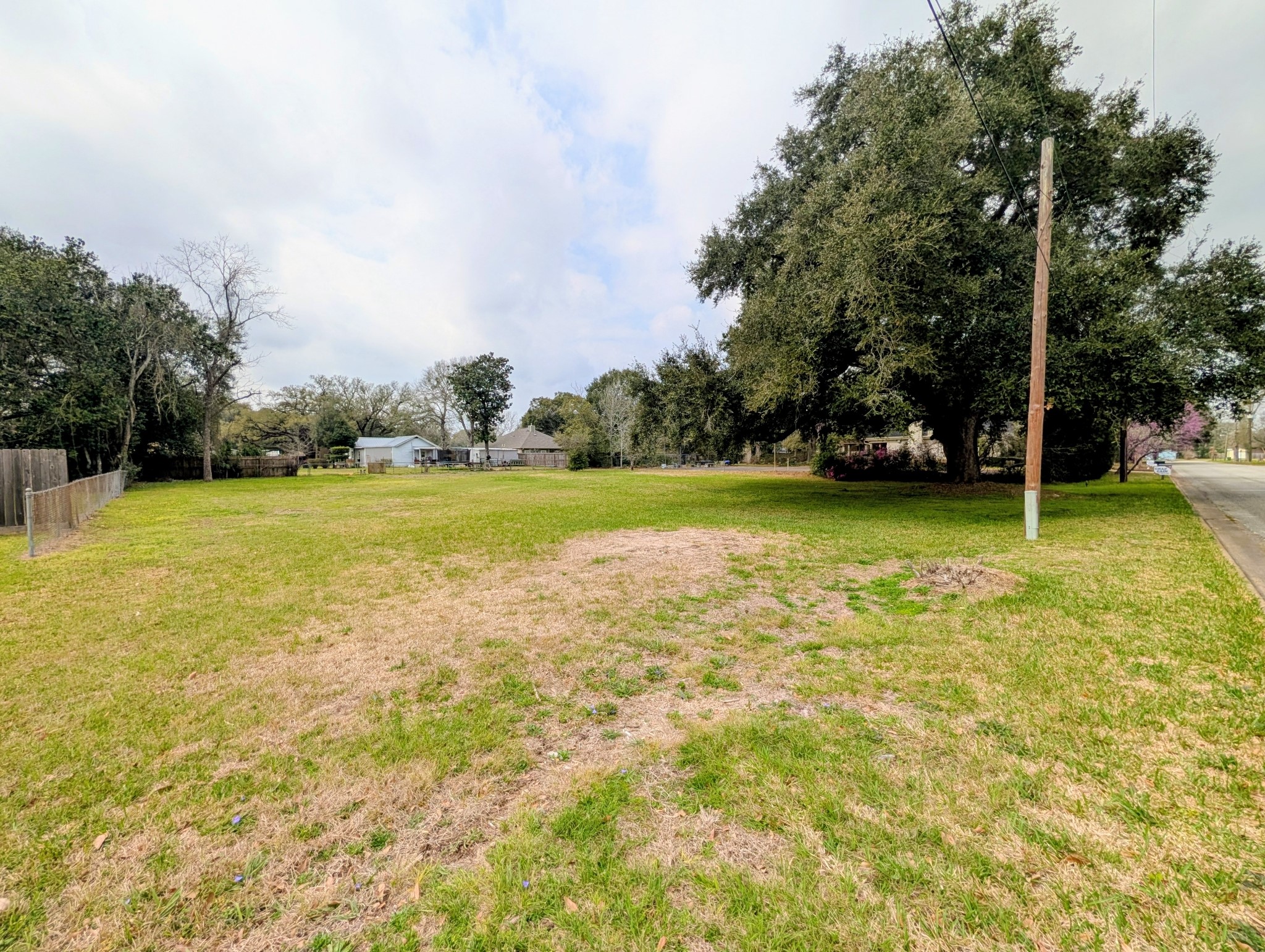 0 Yupon Street Liberty, TX 77575 - Photo 2 of 3 a view of a swimming pool and trees in the background