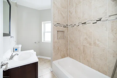 a bathroom with a sink a bathtub and shower