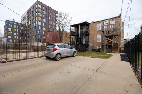a view of a cars park in front of a building