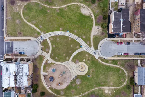 an aerial view of a swimming pool with outdoor seating