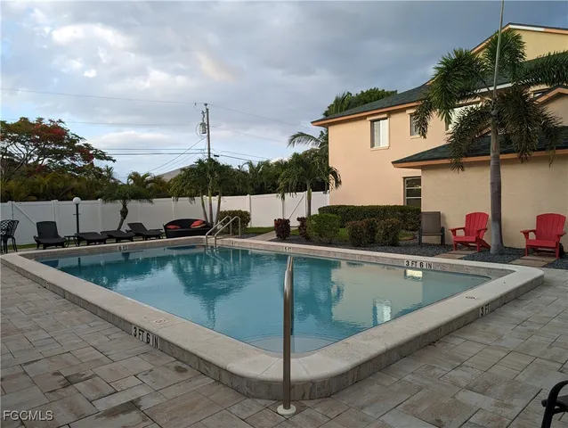 a view of a swimming pool with a yard