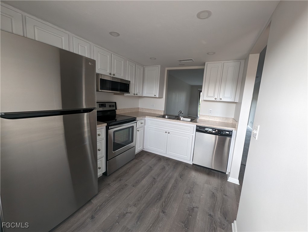 1519 Cape Coral Parkway West, Unit 8 Cape Coral, FL 33914 - Photo 5 of 19 a kitchen with a refrigerator a sink and a stove
