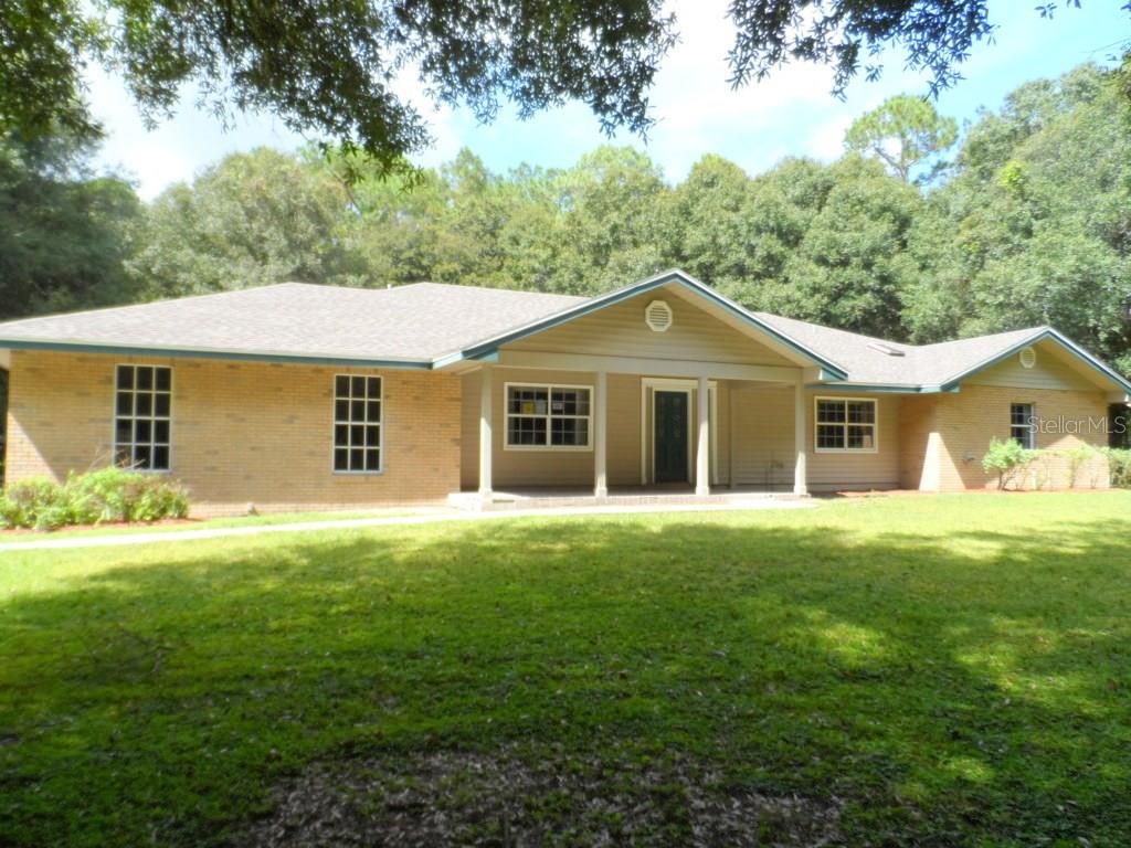 7110 Estate Road Lakeland, FL 33809 - Photo 1 of 1 a front view of a house with a garden