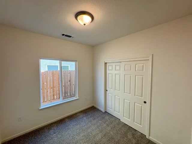 a bathroom with a granite countertop sink a toilet and shower