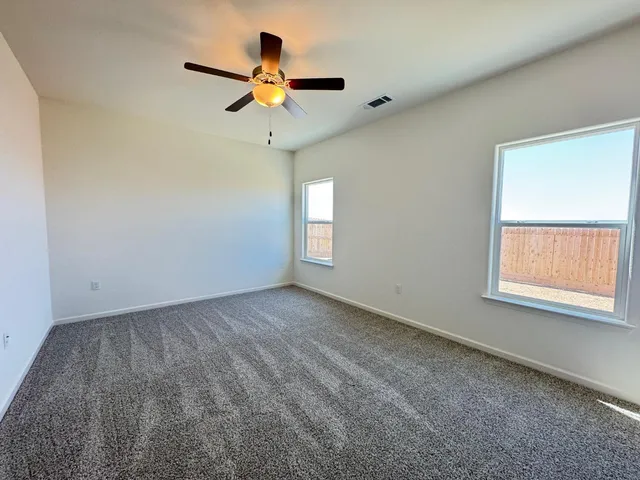 a bathroom with a granite countertop sink a toilet a mirror and shower