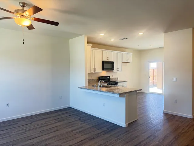 a kitchen with a stove a sink and a microwave