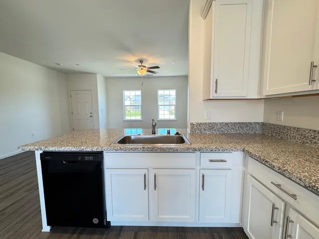 a view of a bathroom with wooden floor and a window