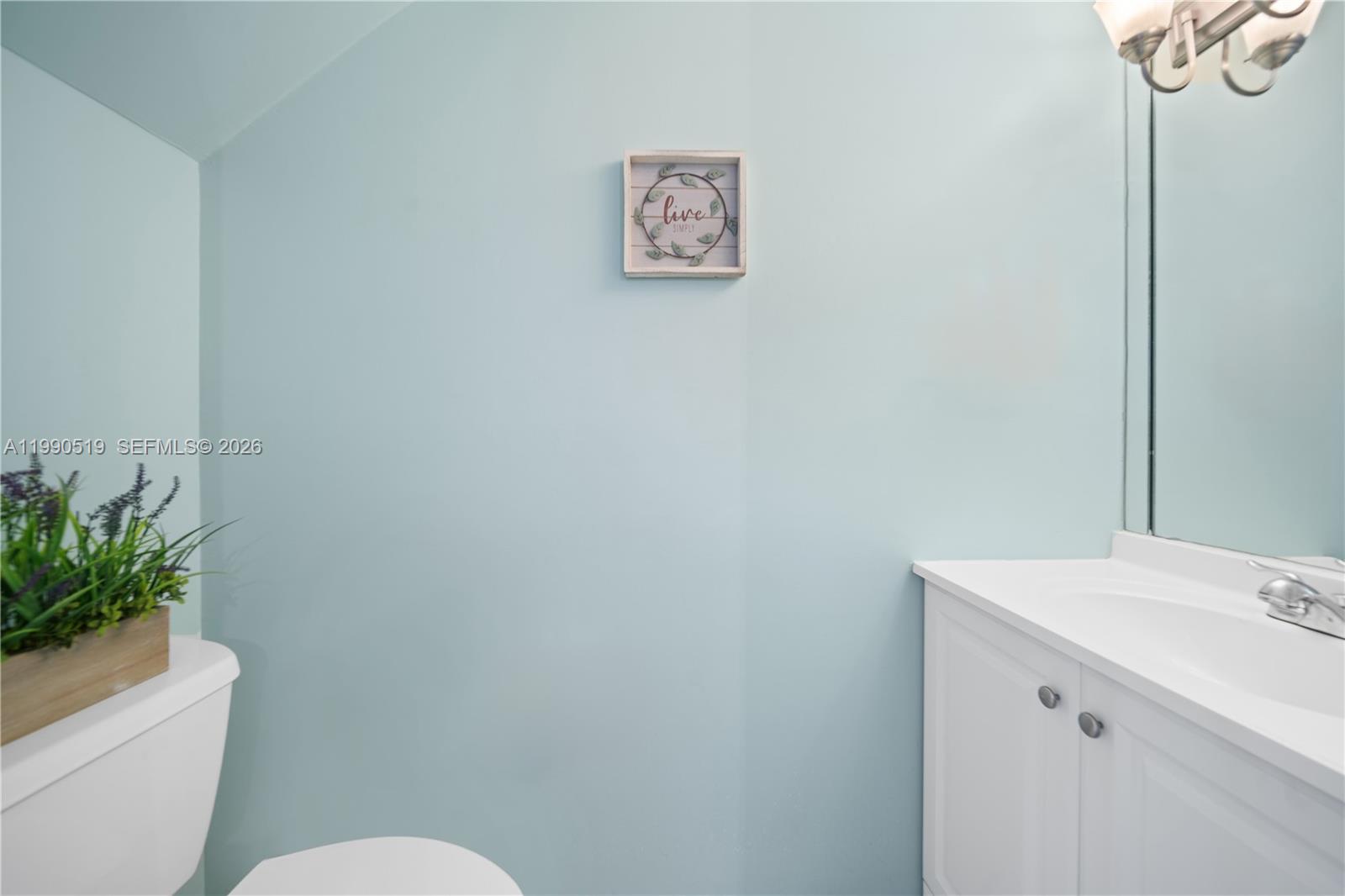 10206 Southwest 77th Court Miami, FL 33156 - Photo 12 of 28 a bathroom with a toilet sink and vanity