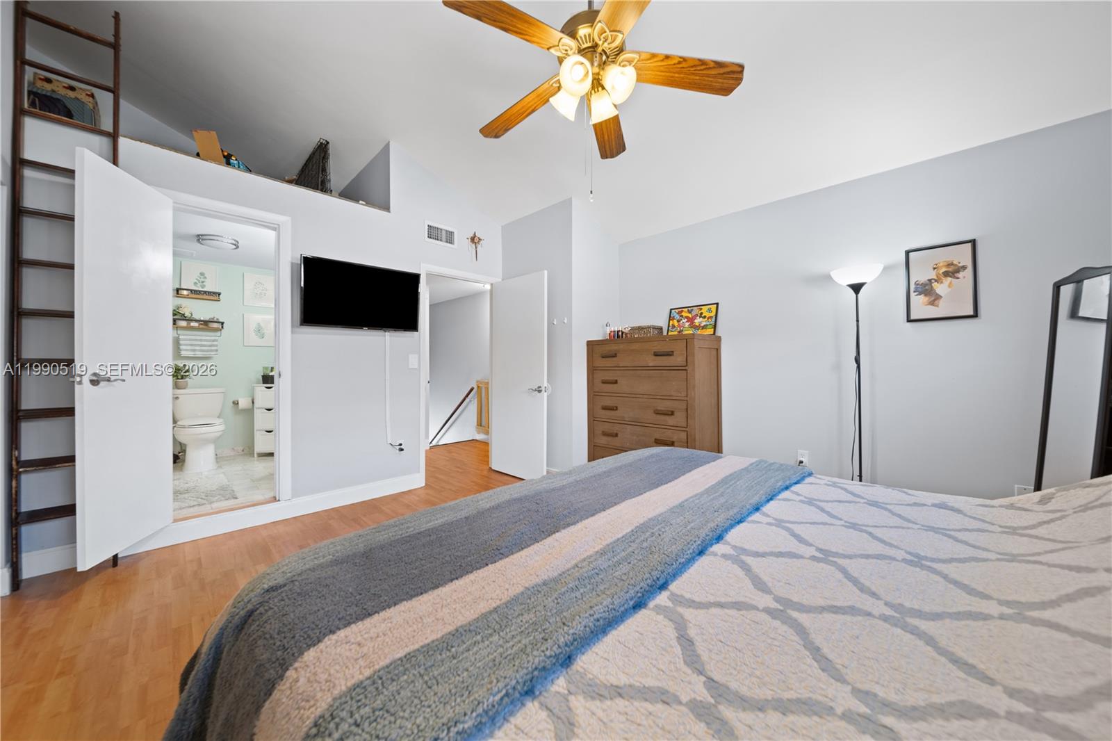 10206 Southwest 77th Court Miami, FL 33156 - Photo 15 of 28 a bedroom with a bed and a flat screen tv