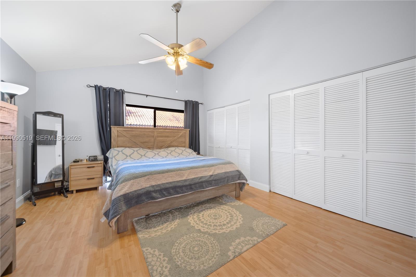 10206 Southwest 77th Court Miami, FL 33156 - Photo 16 of 28 a bedroom with a bed and a chandelier