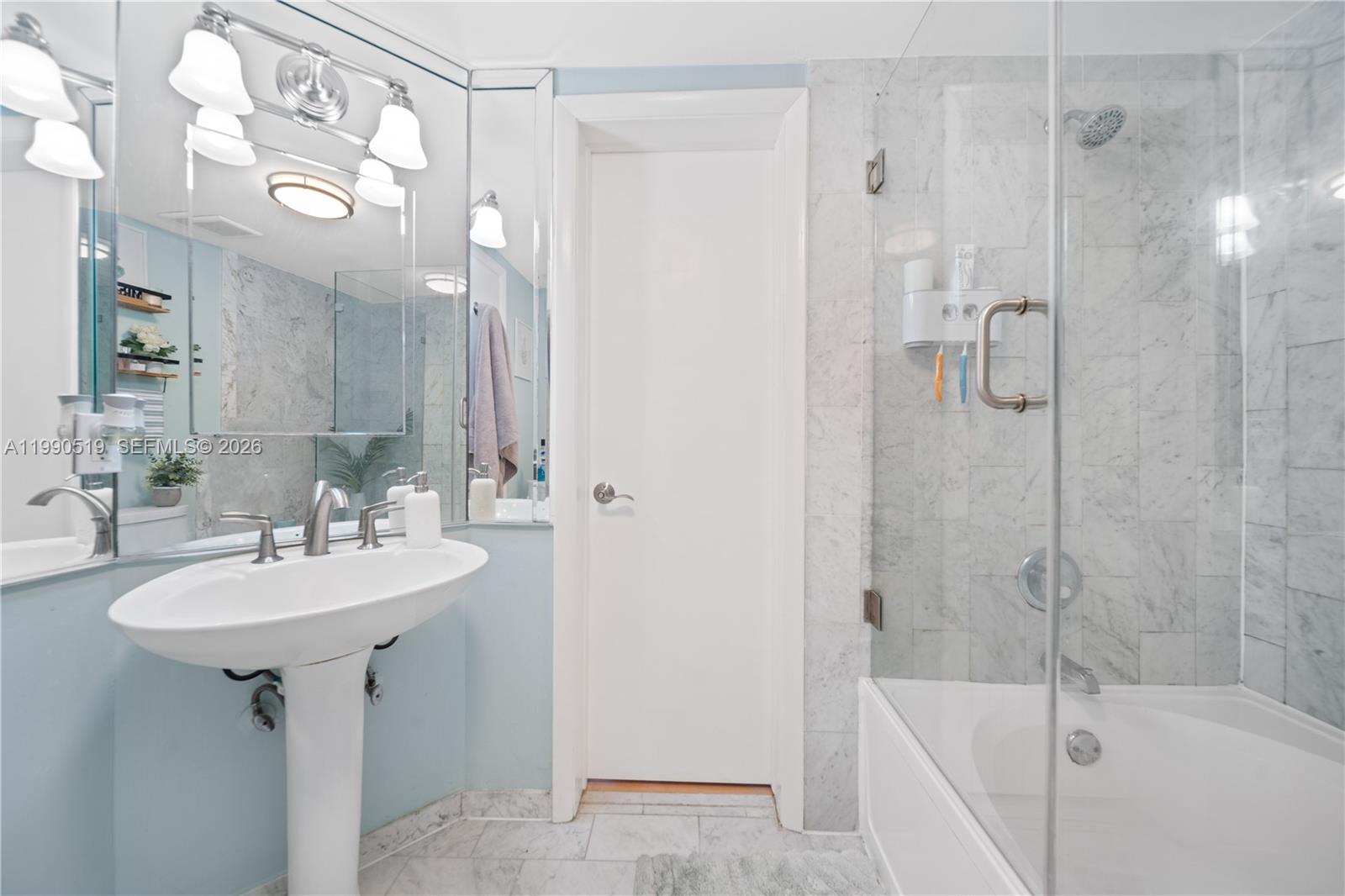 10206 Southwest 77th Court Miami, FL 33156 - Photo 17 of 28 a bathroom with a sink a mirror a bathtub and shower