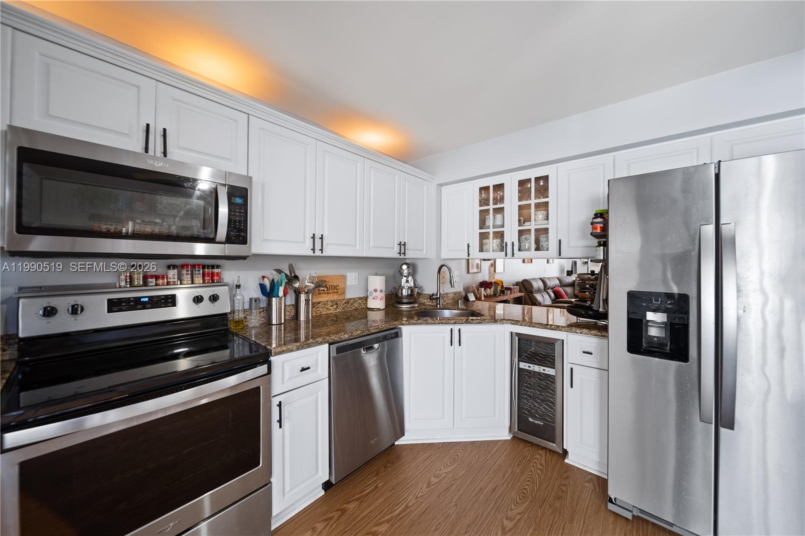 10206 Southwest 77th Court Miami, FL 33156 - Photo 7 of 28 a kitchen with stainless steel appliances a stove microwave and a refrigerator
