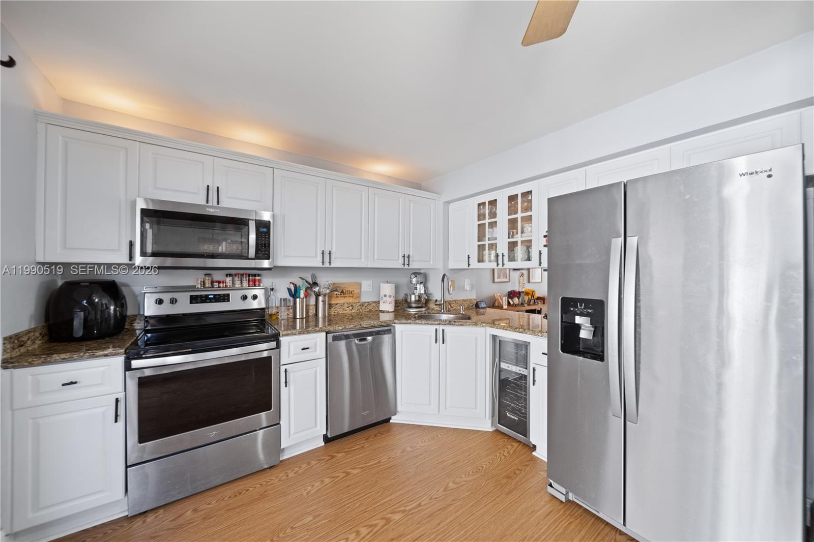 10206 Southwest 77th Court Miami, FL 33156 - Photo 8 of 28 a kitchen with granite countertop a refrigerator stove and microwave
