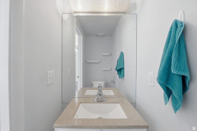 5788 Walden Ridge Drive Murray, UT 84123 - Photo 22 of 29 Bathroom vanity with an integrated sink, a speckled countertop, and a chrome faucet
