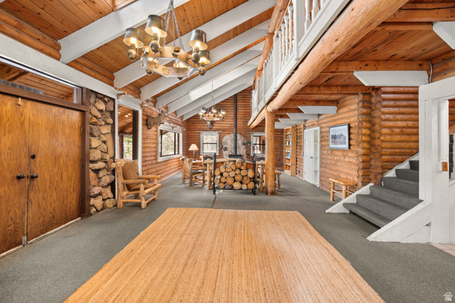 4725 Pine Ridge Road Evanston, UT 82930 - Photo 3 of 82 Open concept interior with exposed wood beams and log walls