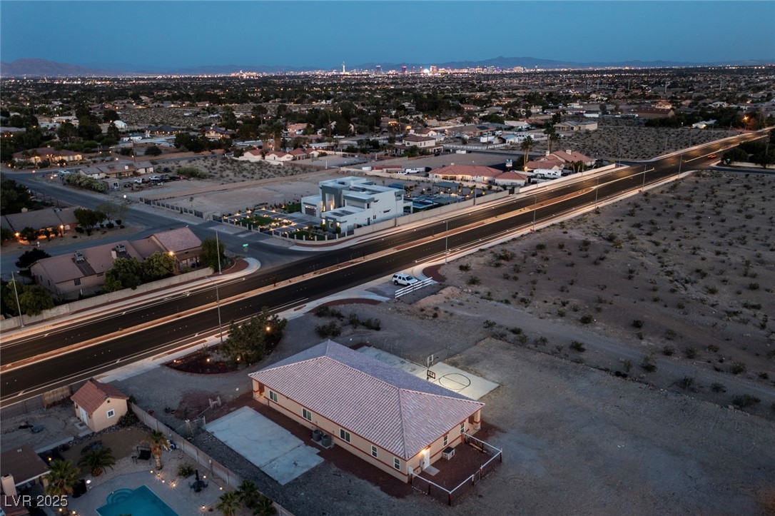 5315 North Fort Apache Road Las Vegas, NV 89149 - Photo 11 of 46 Aerial View of Northwest Corner of home showing Pet Yard in the back and Modernized Fort Apache Road with Metal Art in the Middle of the Road.